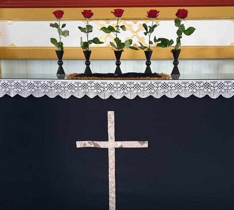 Pitkäperjantain alttarilla Nivalan kirkossa on viisi punaista ruusua